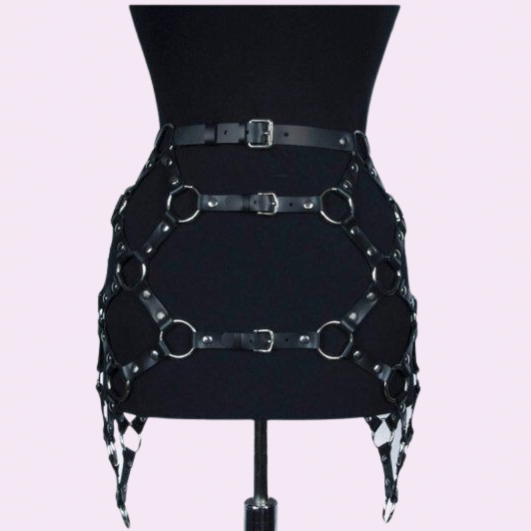our Genuine Leather Harness Skirt featuring silver hardware. Handmade with premium stitching, this chic skirt is perfect for music festivals.