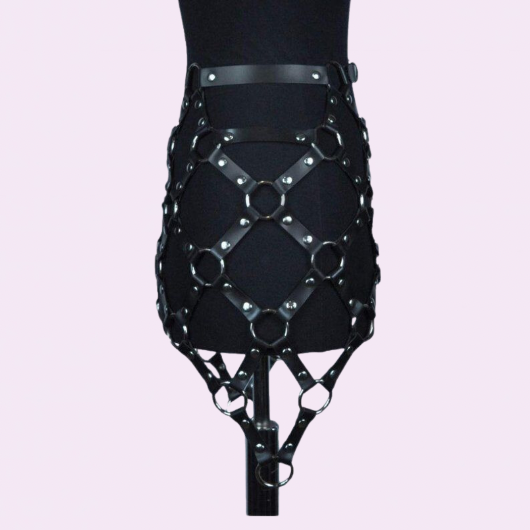 our Genuine Leather Harness Skirt featuring silver hardware. Handmade with premium stitching, this chic skirt is perfect for music festivals.