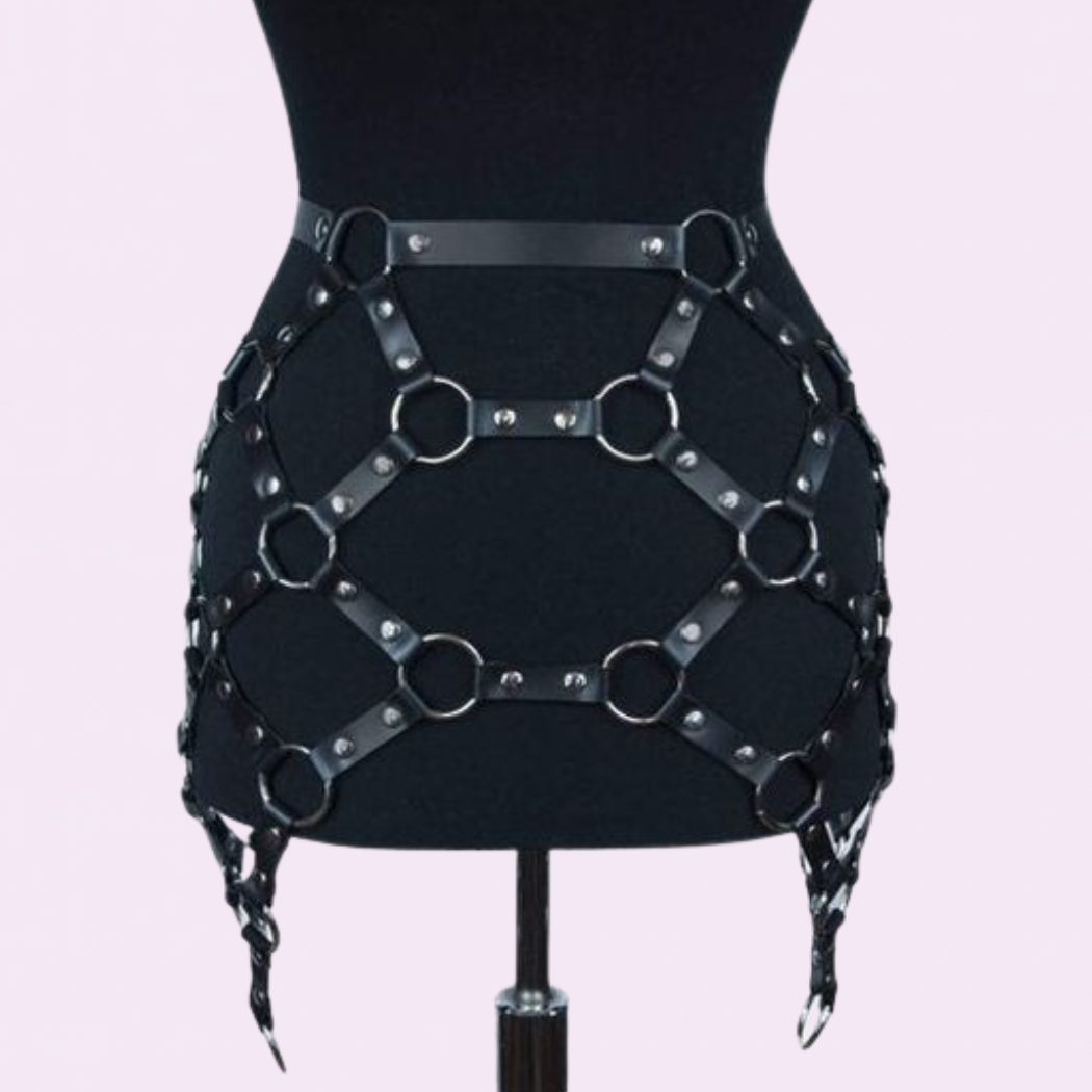 our Genuine Leather Harness Skirt featuring silver hardware. Handmade with premium stitching, this chic skirt is perfect for music festivals.