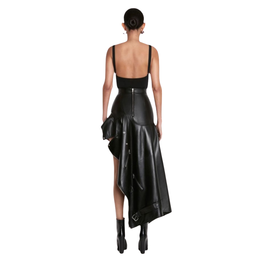 our Mabel Asymmetrical Leather Skirt, featuring a chic side tail design. Crafted from smooth leather for a sleek and comfortable look, this skirt is perfect for the fashion-forward individual looking to make a statement. this leather skirt is size inclusive from XS to 4XL